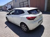 the rear end of a white car parked in a parking lot
