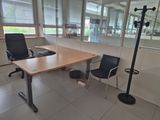 a desk with a chair and a lamp in a room
