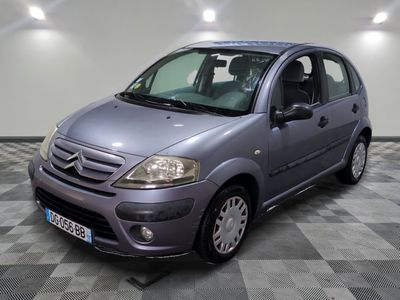 a picture of a small grey car parked in a garage