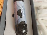 a bottle of wine in a box on a table