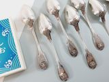 six spoons and a box of ice cream on a table