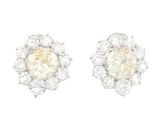 a pair of diamond and white gold earrings