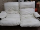 two white recliners that are sitting in a room