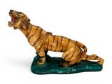 figurine of a tiger on a leaf with its mouth open
