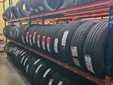 tires are stacked on a rack in a warehouse for sale