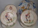two plates with a picture of a boy and a dog on them