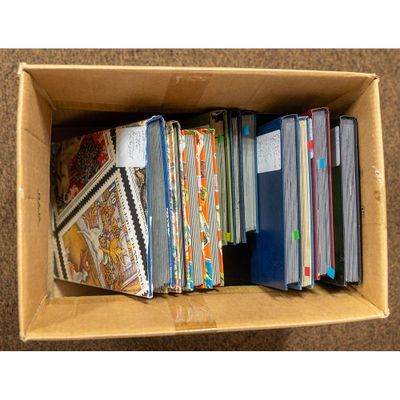 a cardboard box full of books on the floor