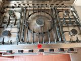 a metal stove top with four burners on it