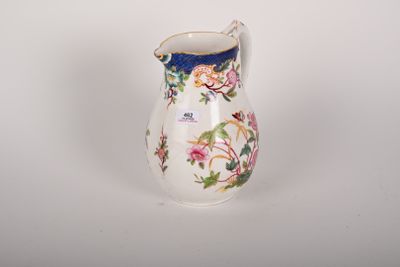 a small white vase with a floral design on it