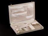 a box with silverware in it on a black surface