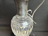 a silver vase that is sitting on a table