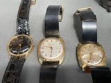 several different types of watches are lined up on a table