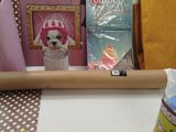 a roll of wrapping paper on a table next to other items