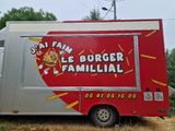 a red food truck that is parked on the side of the road