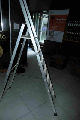 a ladder that is standing in the middle of a room