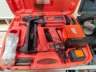a red tool case with tools in it on a table