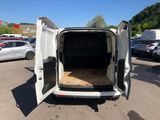 the back of a white van with its doors open in a parking lot