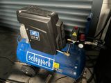 a blue compressor sitting on top of a metal cart