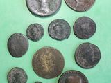 some old roman coins on a green surface with a green background