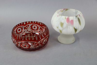 two small vases sitting next to each other on a table