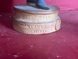 a statue of a man sitting on top of a pedestal