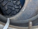 a tire that is sitting in the back of a truck