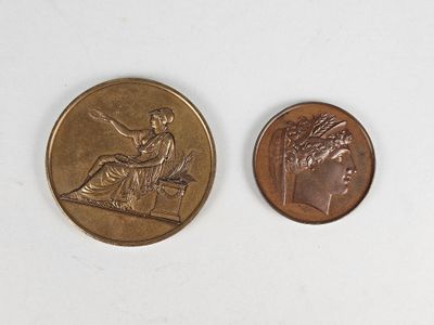 two coins that are sitting side by side on a white surface