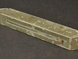 a small piece of green marble on a black surface