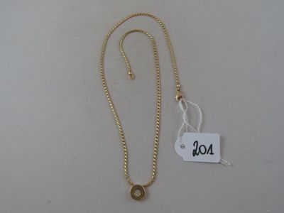 a close up of a gold necklace with a tag on it
