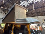 a van that has a roof tent on top of it