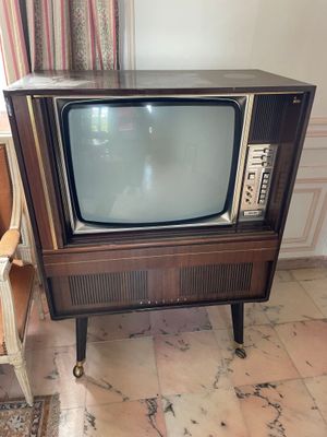 a small television sitting on a small table in a room