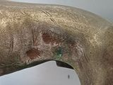 a bronze statue of a horse with a long neck