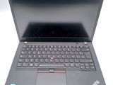 the laptop is open on a white surface with a black keyboard