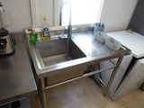 a kitchen with a stainless steel sink and a blender
