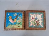 two framed pictures of birds and flowers on the wall