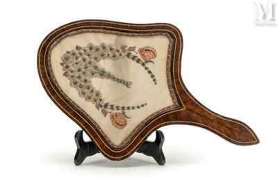 a small fan with a design on it on a stand