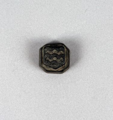 a close up of a small metal object on a white surface