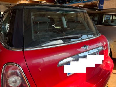 a small red car parked in a parking lot