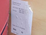 a ticket on the wall next to a red door