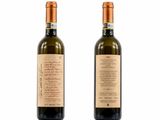 On voit deux bouteilles de vin posées sur une surface blanche