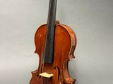 an old violin sitting on a table with a bow on it