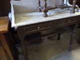a marble sink sitting on top of a wooden table