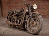 a old motorcycle that is sitting in the dirt