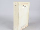 an old book sitting on top of a table next to a white wall