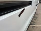 a picture of a white van parked in a parking lot