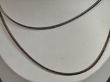 silver chain on a mannequin necklace on a white mannequin