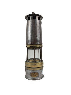 an old fashioned metal and glass lantern on a white background
