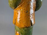 a ceramic figurine of a man with a hat on his head