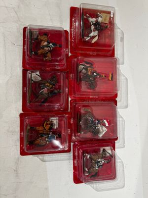 a lot of small plastic toys in a red case