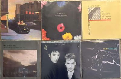 a lot of different album covers on a table